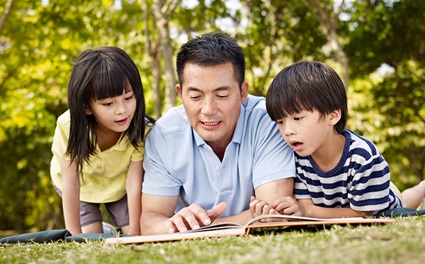 Father and children reading